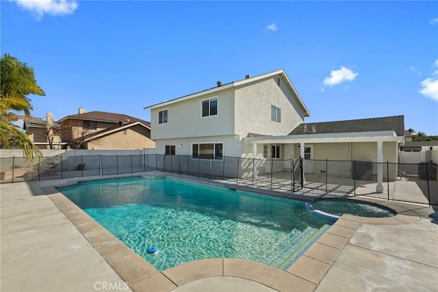 view of swimming pool with an in ground hot tub and a patio area