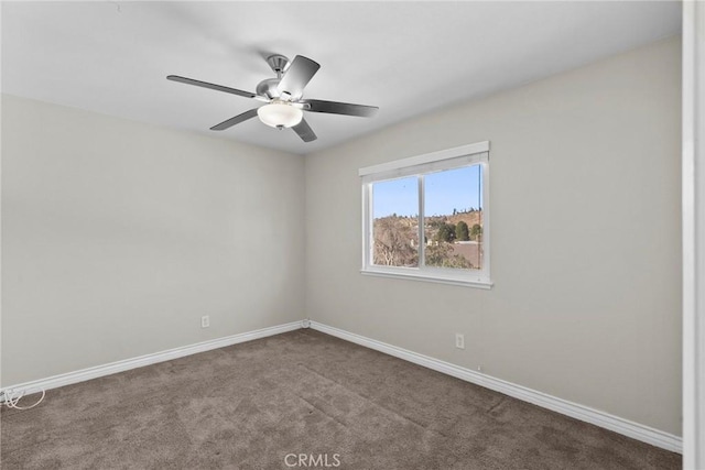 spare room featuring ceiling fan and carpet flooring