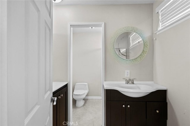 bathroom with tile patterned floors, vanity, and toilet