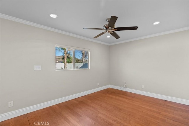 empty room with hardwood / wood-style flooring, ceiling fan, and crown molding