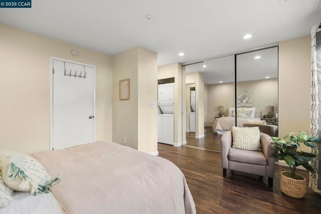 bedroom with dark wood-type flooring, a closet, and stacked washing maching and dryer