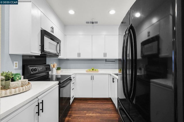 kitchen with black appliances, white cabinets, and dark hardwood / wood-style floors