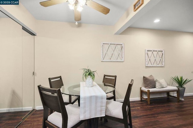 dining space featuring ceiling fan, dark wood-type flooring, and beam ceiling