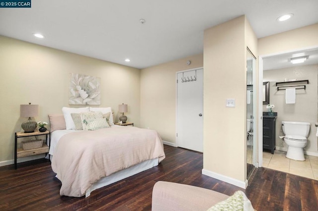 bedroom featuring hardwood / wood-style flooring and ensuite bath