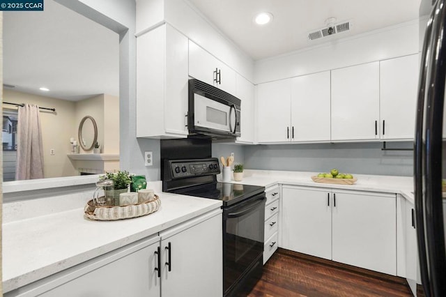 kitchen featuring dark wood-type flooring, white cabinetry, and black appliances