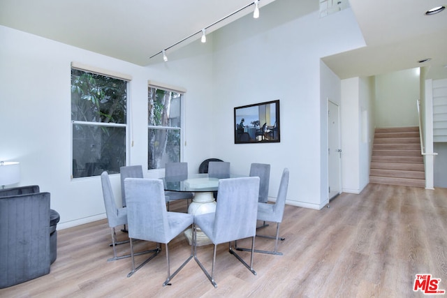 dining area featuring track lighting and light wood-type flooring