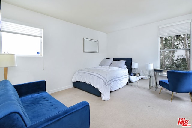 bedroom featuring light carpet