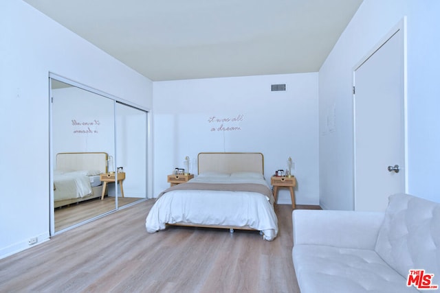 bedroom with hardwood / wood-style flooring and a closet