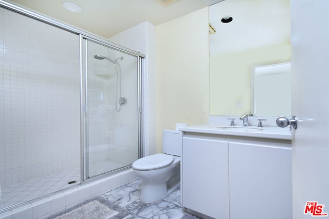 bathroom with vanity, toilet, and walk in shower