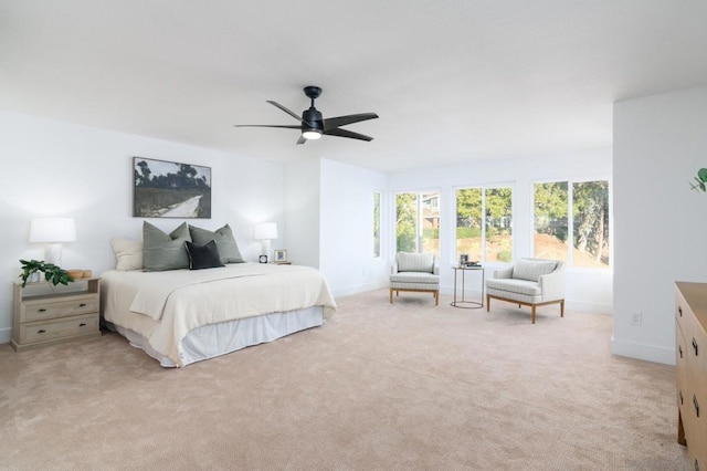 bedroom with ceiling fan and light carpet