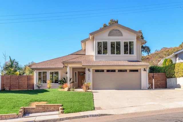 view of front of home featuring a garage and a front lawn