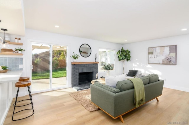 living room featuring light hardwood / wood-style floors and a fireplace