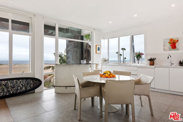 dining room featuring sink and a water view