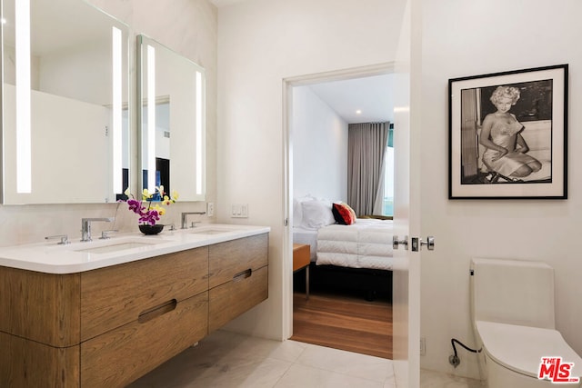 bathroom featuring vanity, toilet, and tile patterned floors