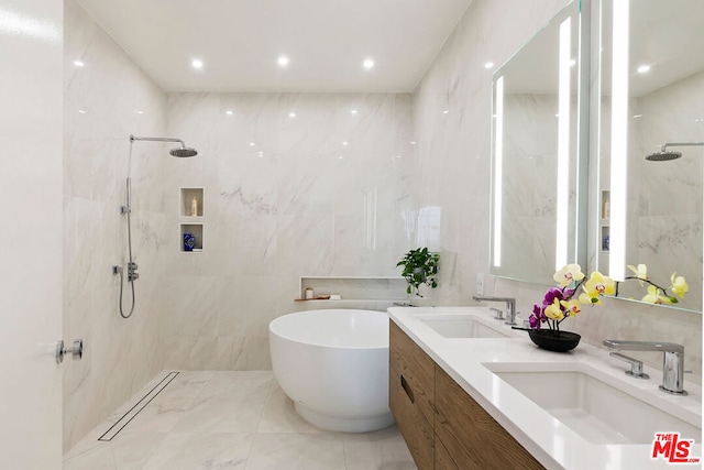 bathroom featuring vanity, tile walls, and separate shower and tub