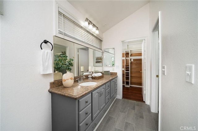 bathroom featuring lofted ceiling and vanity