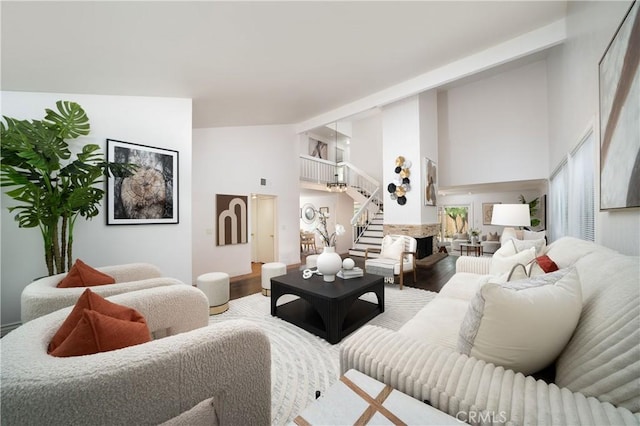 living room with hardwood / wood-style floors and a high ceiling