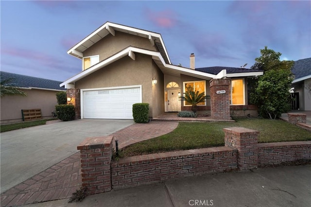 view of front facade with a garage and a lawn