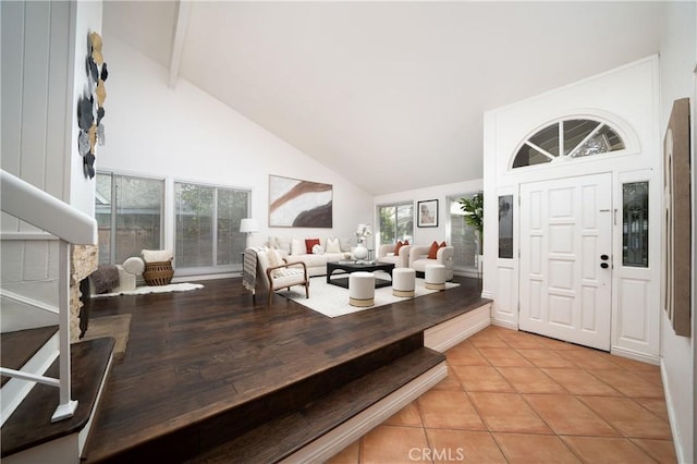 tiled foyer featuring high vaulted ceiling