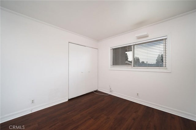 unfurnished room featuring crown molding and dark hardwood / wood-style flooring