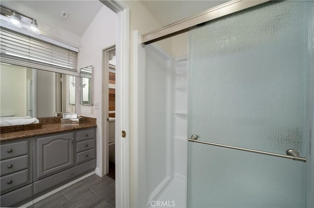 bathroom with vanity and a shower with door