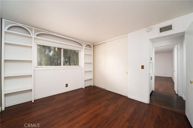 empty room with dark hardwood / wood-style flooring