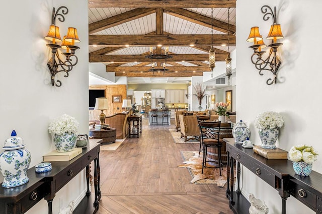 hall featuring wooden ceiling, wood-type flooring, and vaulted ceiling with beams