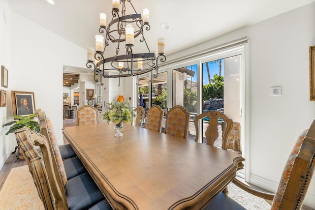 dining area featuring an inviting chandelier and hardwood / wood-style flooring