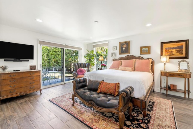 bedroom featuring access to exterior and light hardwood / wood-style floors