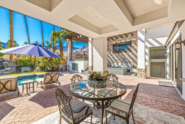 view of patio featuring a balcony