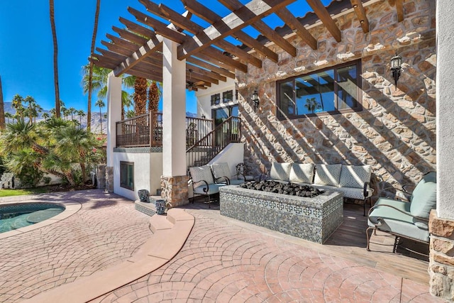 view of patio with a balcony, a pergola, a swimming pool, and an outdoor living space with a fire pit