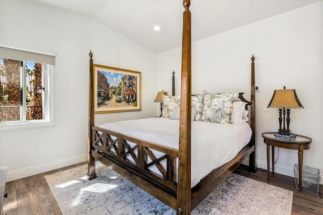 bedroom with dark wood-type flooring and vaulted ceiling