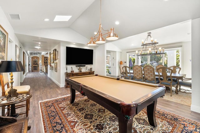 game room with hardwood / wood-style flooring, lofted ceiling with skylight, and billiards