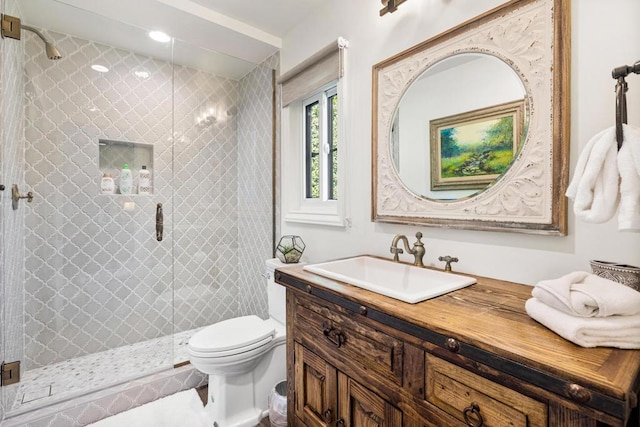 bathroom with vanity, toilet, and walk in shower