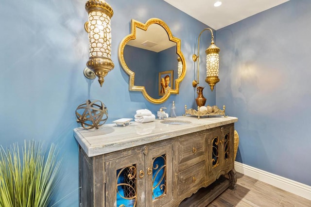 bathroom with hardwood / wood-style flooring and vanity