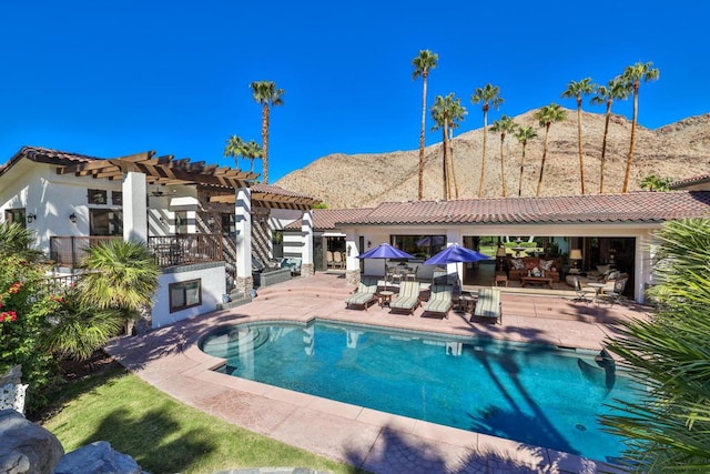 view of swimming pool featuring a mountain view, a patio, and a pergola