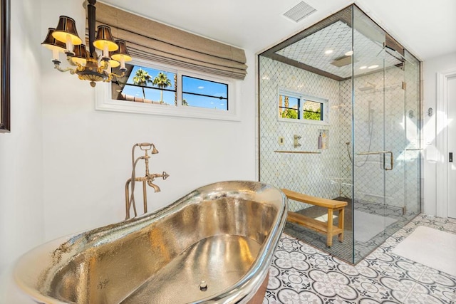 bathroom with sink, tile patterned floors, a shower with door, and a chandelier