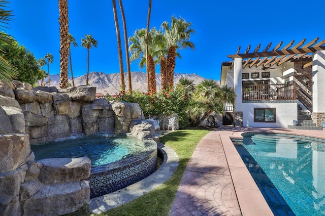 view of pool with a mountain view, a pergola, and a patio area