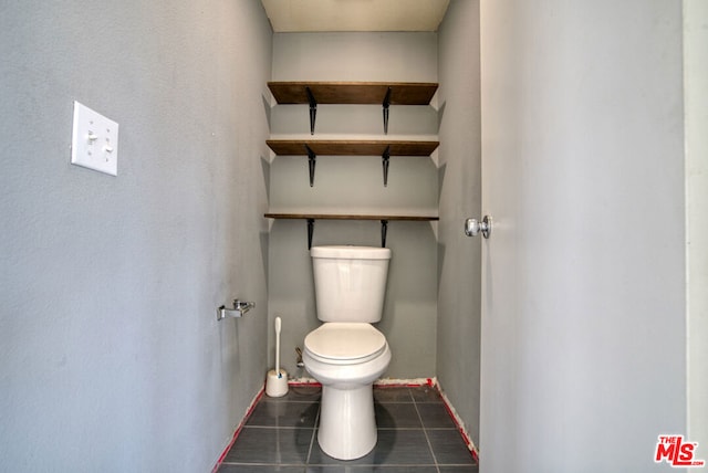 bathroom featuring toilet and tile patterned floors