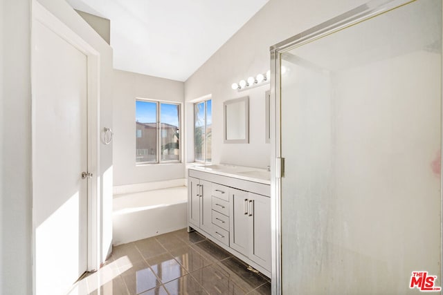 bathroom with a tub, tile patterned flooring, and vanity