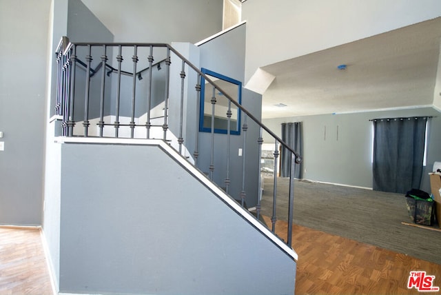 stairs with hardwood / wood-style floors