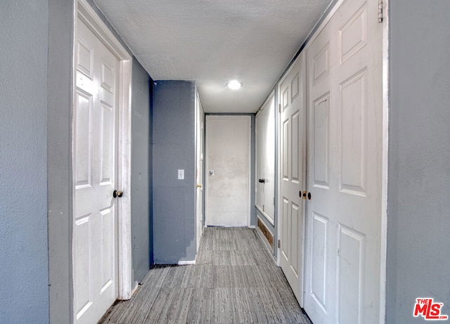 corridor with a textured ceiling