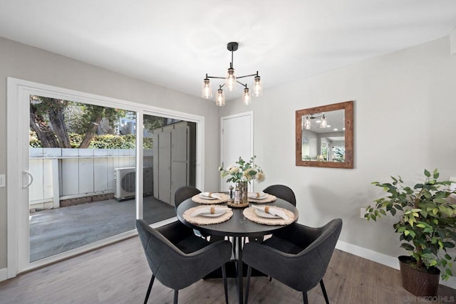 dining space featuring a notable chandelier and hardwood / wood-style flooring