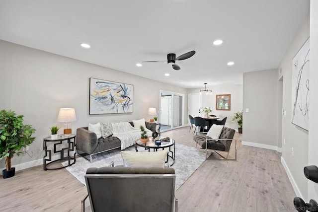 living room with light wood-type flooring and ceiling fan