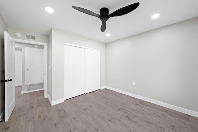 unfurnished bedroom with a closet, ceiling fan, and light hardwood / wood-style flooring