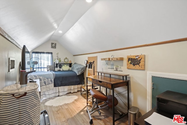 bedroom featuring hardwood / wood-style floors and vaulted ceiling