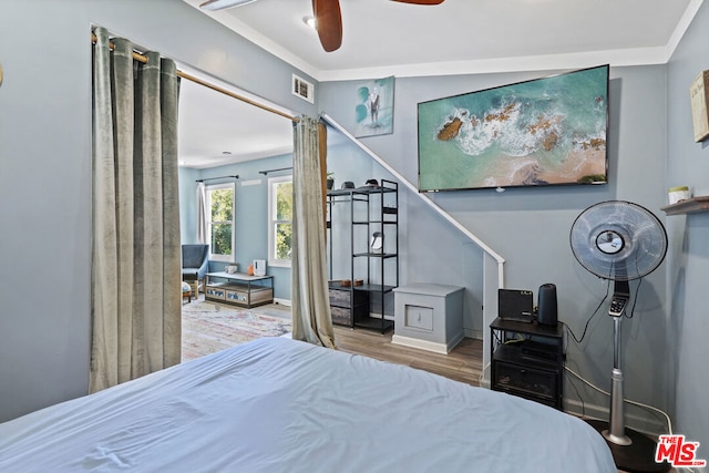 bedroom featuring hardwood / wood-style floors and ceiling fan