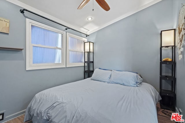 bedroom with ceiling fan and dark hardwood / wood-style floors