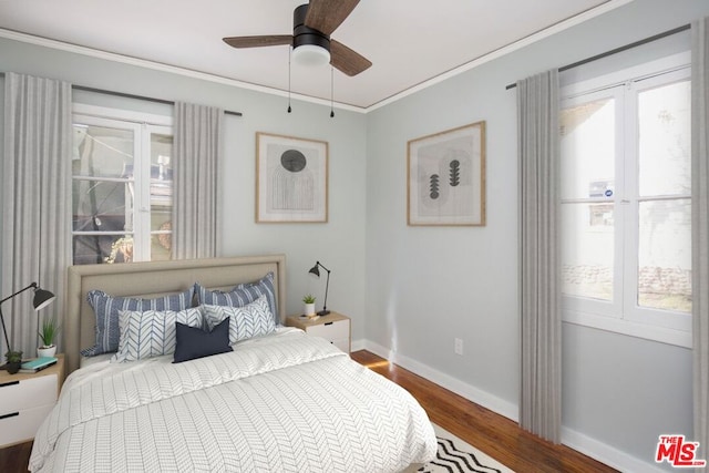 bedroom with crown molding, multiple windows, hardwood / wood-style flooring, and ceiling fan