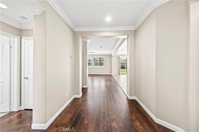 hallway with dark hardwood / wood-style flooring and ornamental molding